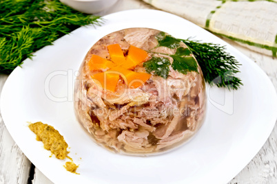 Jellied in plate with mustard and dill on board