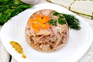 Jellied in plate with mustard and dill on board