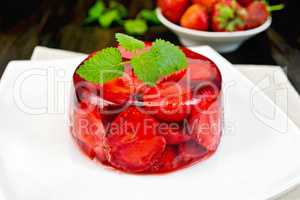Jelly strawberry with mint and berries on board