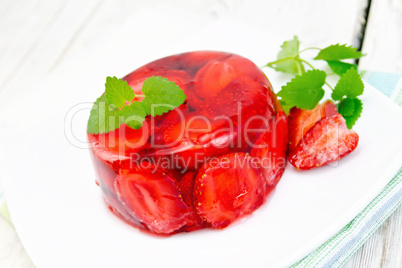 Jelly strawberry with mint and berries on light board