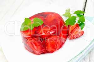 Jelly strawberry with mint and berries on light board