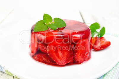Jelly strawberry with mint in plate on board