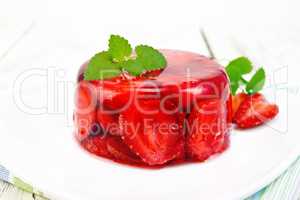 Jelly strawberry with mint in plate on board