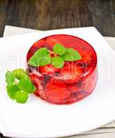Jelly strawberry with mint on napkin and dark board