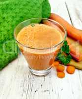 Juice carrot with vegetables and napkin on board