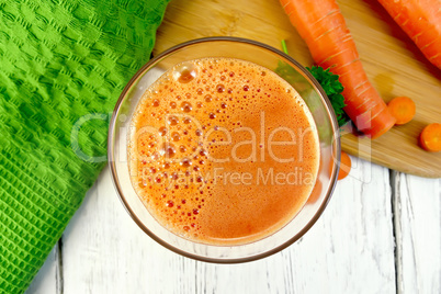 Juice carrot with vegetables and napkin on board top