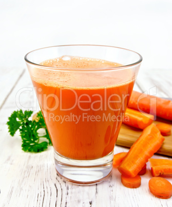 Juice carrot with vegetables and parsley on board