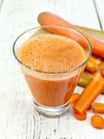 Juice carrot with vegetables on board