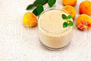 Milkshake apricot with mint on granite table