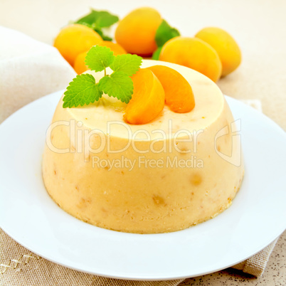 Panna cotta apricot with fruit and mint on table
