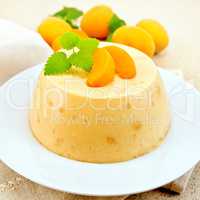 Panna cotta apricot with fruit and mint on table