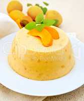 Panna cotta apricot with mint and fruits on napkin