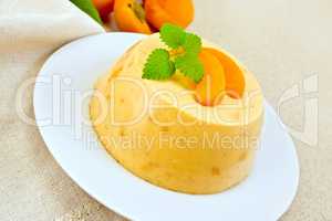 Panna cotta apricot with mint and napkin on table