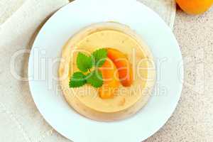 Panna cotta apricot with mint on napkin top