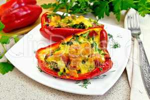 Pepper stuffed with sausage and cheese in plate on table