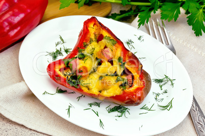 Pepper stuffed with sausage and cheese on granite table
