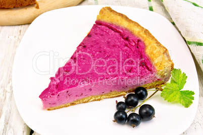 Pie of black currants in plate on board