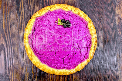 Pie of black currants on dark board top