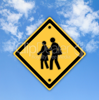 School warning sign on yellow with a blue sky background