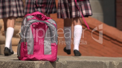 School Backpack And Students Walking