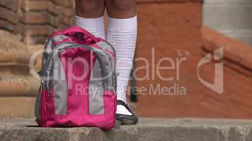 Female Student Standing Near Backpack