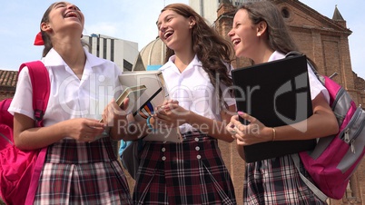 Teen Female Students Talking And Holding Books