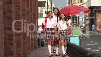 School Girls Walking On Sidewalk