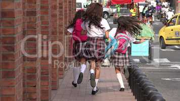 School Girls Running On Sidewalk