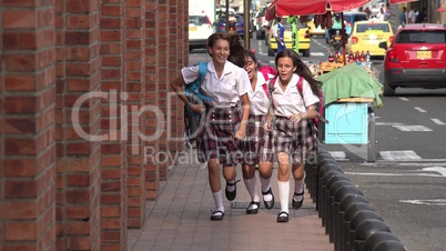 Female Students Running On Sidewalk