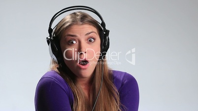 Energetic young girl listening music in headphones