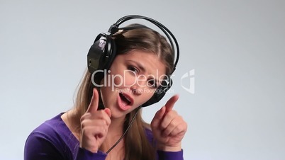 Excited brunette girl in headphones enjoying music