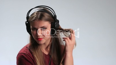 Sexy woman wearing headphones and listening music