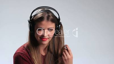 Provocative young brunette posing with headphones