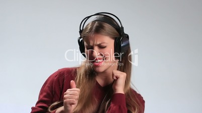 Happy cheerful girl enjoying music in headphones