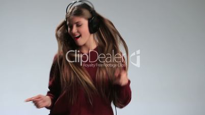 Beautiful female dancing to music in headphones