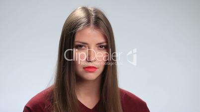 Young woman with sad expression over white