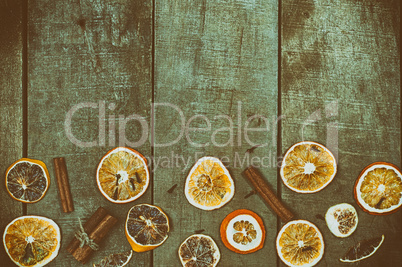 Dried slices of oranges and lemon on a wooden surface