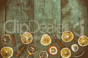 Dried slices of oranges and lemon on a wooden surface