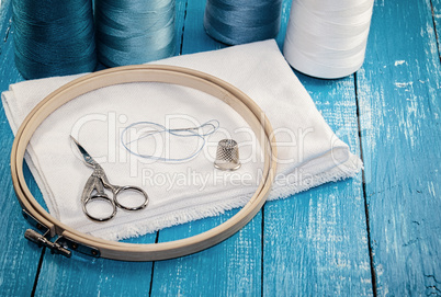Threads in spools with white cloth for the embroidery and sewing