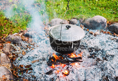 Metal pot over a campfire outdoors