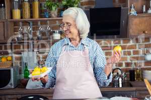 Woman looking at lemons in kitchen