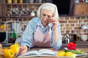 Senior woman with cookbook