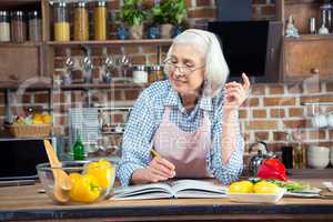 Senior woman with cookbook