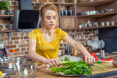 Woman holding green onions