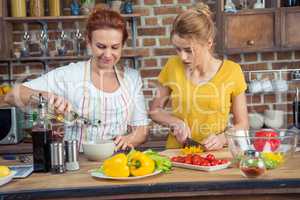 Mother and daughter cooking together