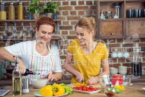 Mother and daughter cooking together