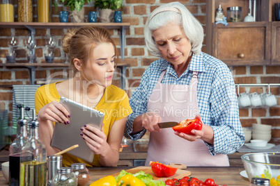 Granddaughter and grandmother cooking together