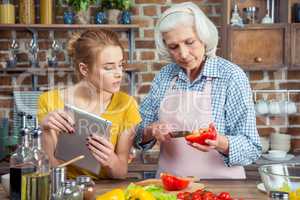 Granddaughter and grandmother cooking together