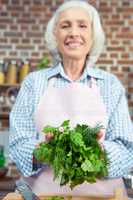 Woman holding green herbs