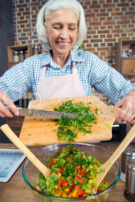 Woman cutting salad greens